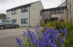 Blackhills Court building with flowers on the side and parking space in front