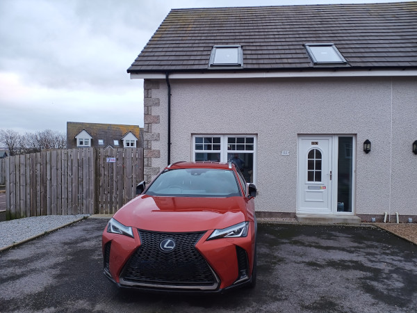 Front of the property on Ladysbridge Drive with tarmacked driveway and a side gate