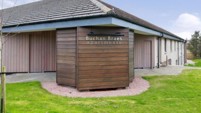 Front of the Buchan Braes apartments building with grass and pavement