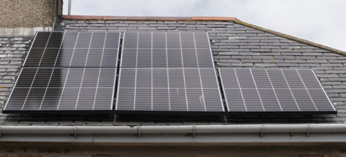 Solar PV panels on a house with a slate roof covering