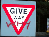 Antisocial Behaviour showing graffiti on road sign