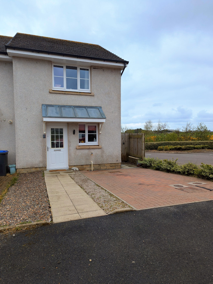 Front of the house at 7 Marshall Close with driveway, path to the front door, gravel in-between and side gate to the garden