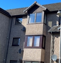 Front of the block with windows and sloped roof