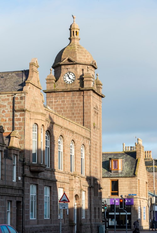 An external picture of the pink granite Carnegie Building in Peterhead which currently houses the Public Library and Arbuthnot Museum