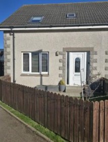 Front of 36A Knock Avenue in Whitehills with wooden fenced front garden