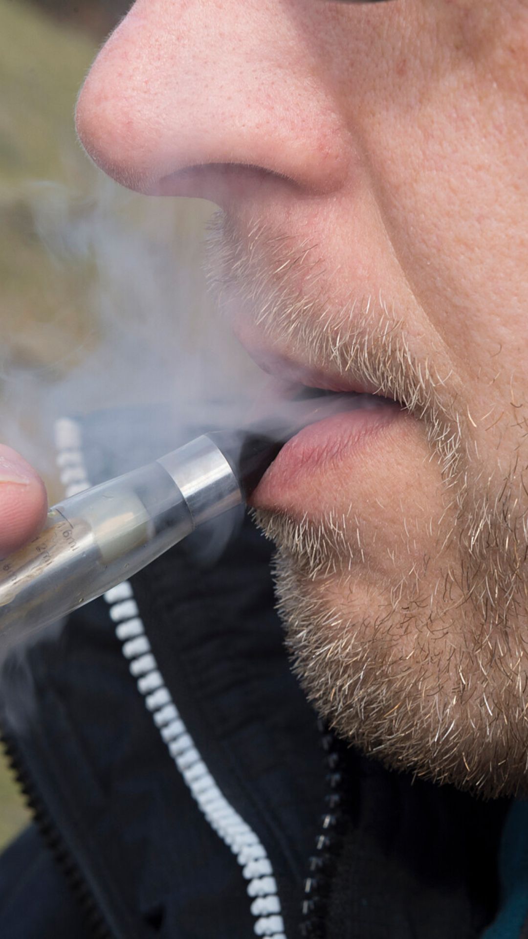 Close up of someone vaping.